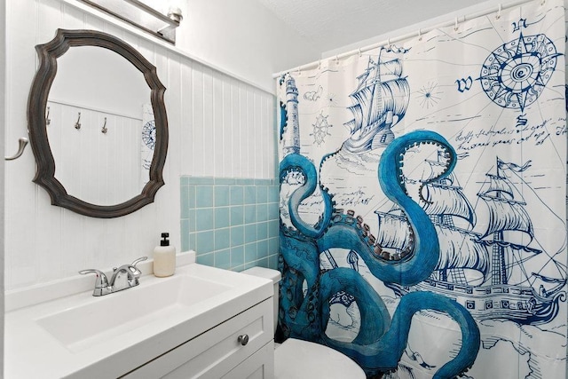 bathroom featuring walk in shower, vanity, and toilet