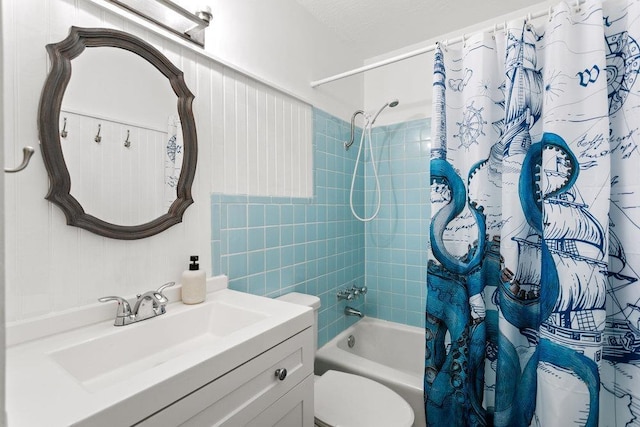 full bathroom featuring vanity, shower / bath combination with curtain, and toilet