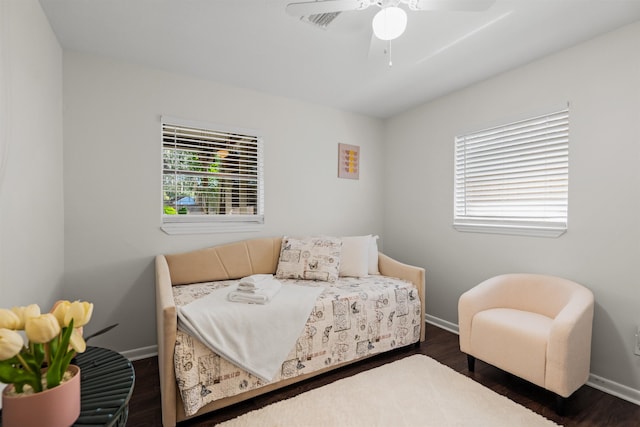 bedroom featuring a ceiling fan, baseboards, and wood finished floors