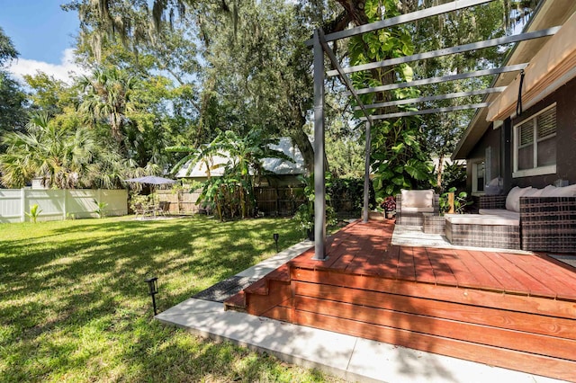 wooden deck with a fenced backyard, a pergola, and a yard