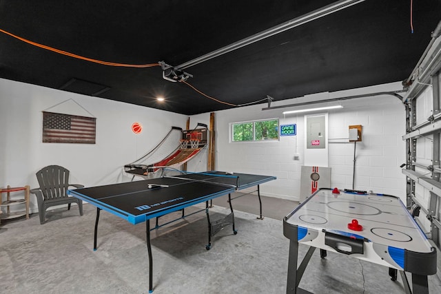 110 Dory Rd, Saint Augustine, FL 32086 - playroom with concrete floors, concrete block wall, electric panel, and a garage