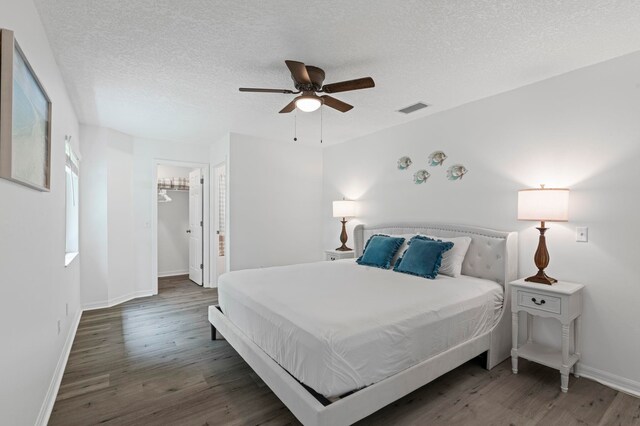 110 Dory Rd, Saint Augustine, FL 32086 - bedroom featuring wood finished floors, a textured ceiling, baseboards, ceiling fan, and a spacious closet