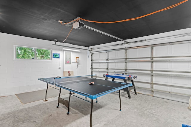 110 Dory Rd, Saint Augustine, FL 32086 - game room with concrete floors, a garage, concrete block wall, and electric panel