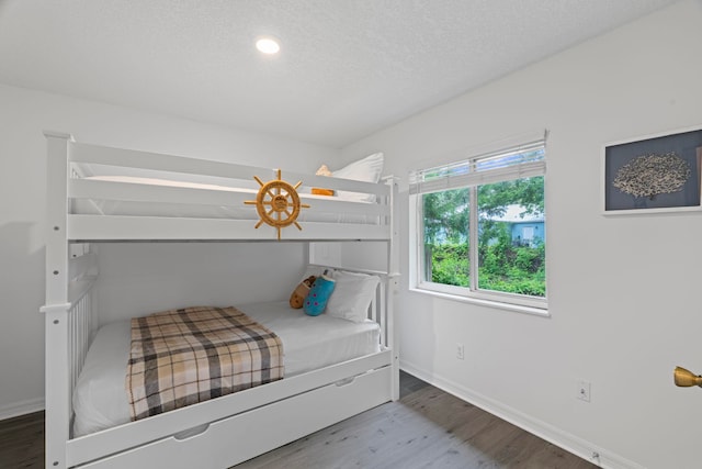 110 Dory Rd, Saint Augustine, FL 32086 - bedroom with wood finished floors, baseboards, and a textured ceiling