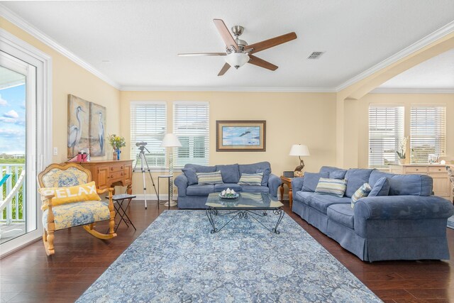 living room with ceiling fan, dark hardwood / wood-style flooring, and ornamental molding