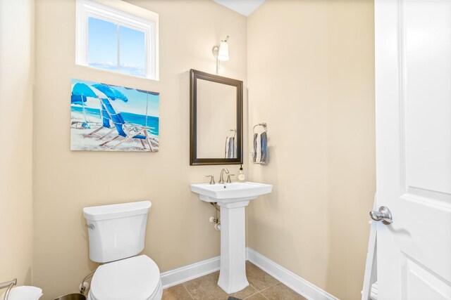 bathroom with tile patterned floors and toilet