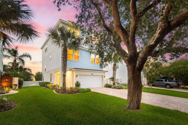 view of front of house with a lawn and a garage