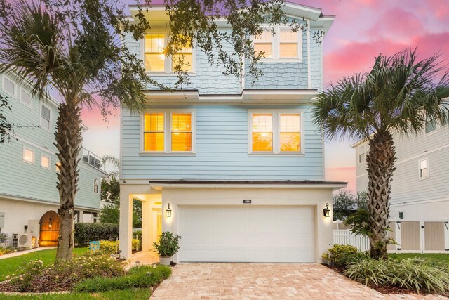 view of front of home featuring ac unit and a garage