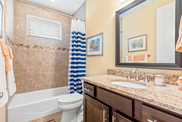 full bathroom with tile patterned flooring, vanity, toilet, and shower / bath combo