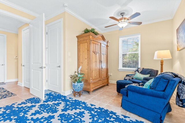 sitting room featuring tile patterned floors, ceiling fan, and crown molding