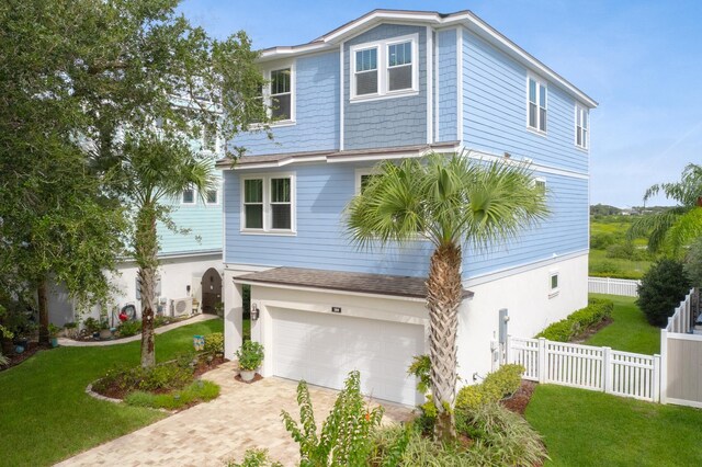 view of front facade featuring a front lawn and a garage