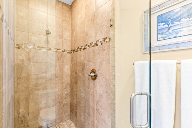 bathroom featuring a shower with door