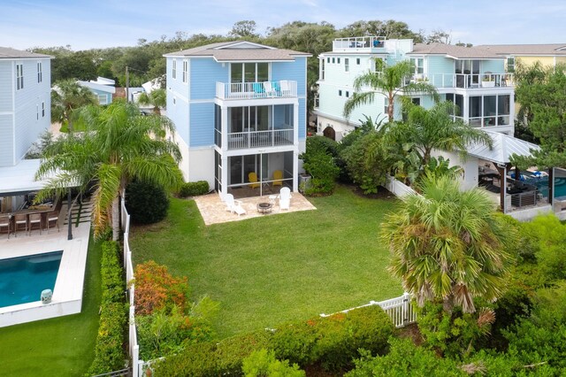 rear view of house featuring a lawn and a patio area