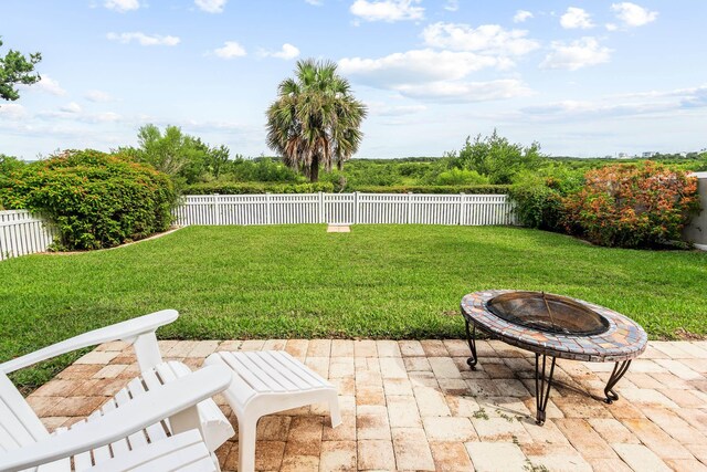 view of yard featuring a fire pit and a patio