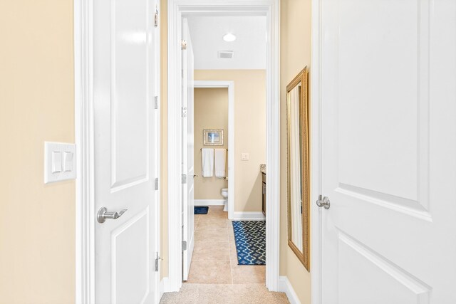 hall featuring light tile patterned flooring