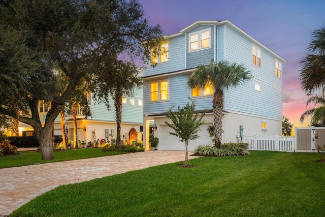 view of front of home with a lawn and a garage