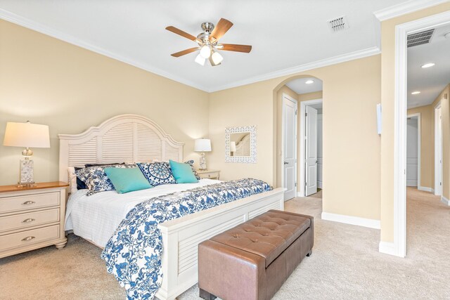 bedroom featuring ceiling fan, crown molding, and light carpet