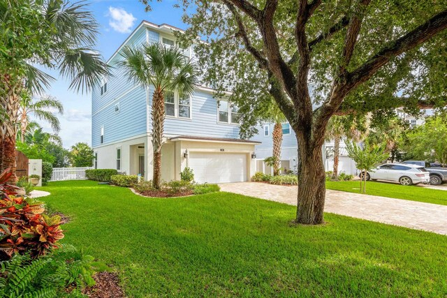 view of front facade featuring a front lawn and a garage