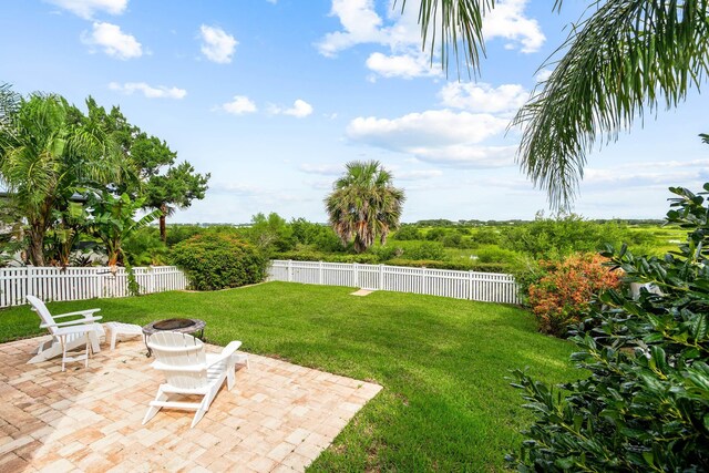 view of yard featuring a patio area and an outdoor fire pit