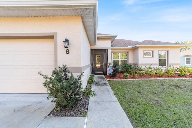 entrance to property with a lawn