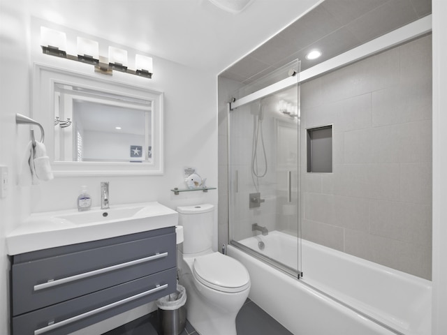 full bathroom featuring toilet, vanity, and shower / bath combination with glass door