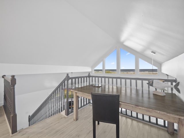 additional living space with light wood-type flooring and lofted ceiling