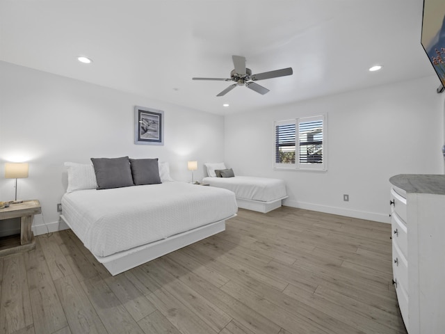 bedroom featuring ceiling fan and light hardwood / wood-style floors