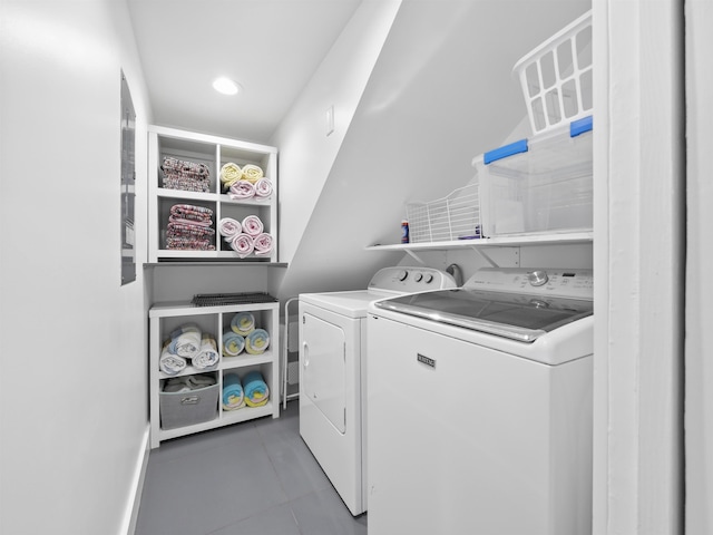 clothes washing area featuring independent washer and dryer and dark tile patterned floors