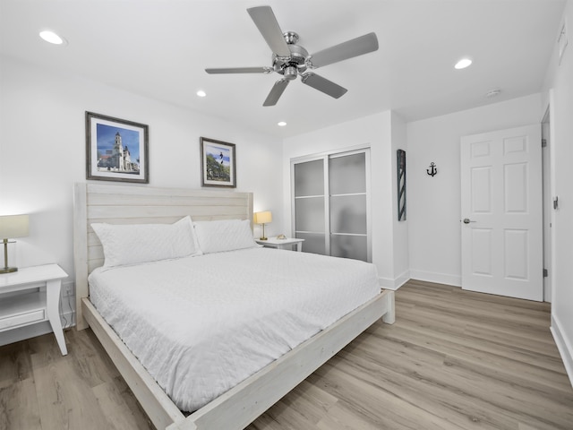 bedroom featuring ceiling fan, a closet, and light hardwood / wood-style flooring