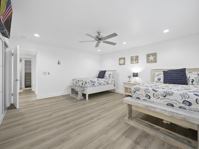 bedroom with ceiling fan and light hardwood / wood-style floors