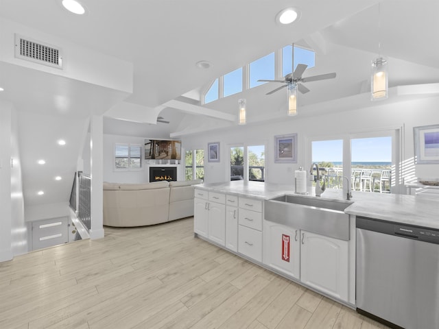 kitchen featuring decorative light fixtures, white cabinets, dishwasher, and sink