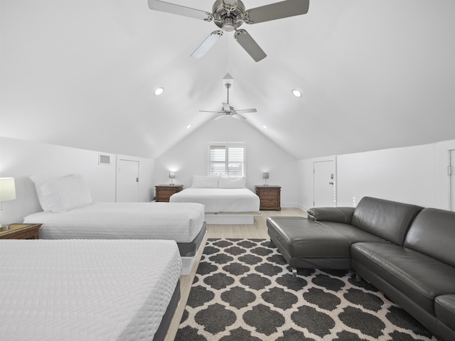 bedroom featuring ceiling fan, hardwood / wood-style floors, and vaulted ceiling