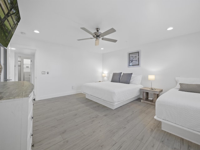 bedroom with ceiling fan and light wood-type flooring