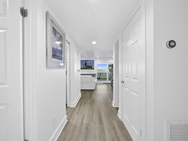 corridor with light hardwood / wood-style flooring