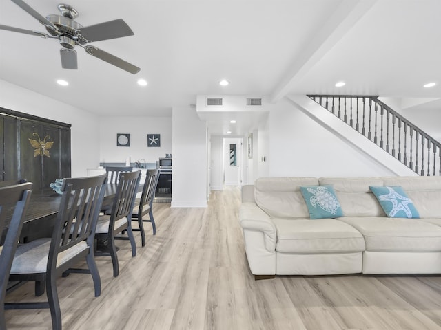 living room featuring beam ceiling, ceiling fan, and light hardwood / wood-style floors