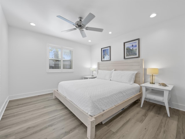 bedroom with ceiling fan and light hardwood / wood-style flooring