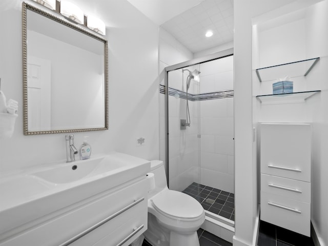 bathroom with toilet, vanity, tile patterned flooring, and a shower with door