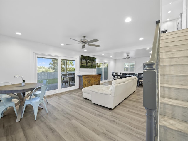 living room featuring ceiling fan and light hardwood / wood-style flooring