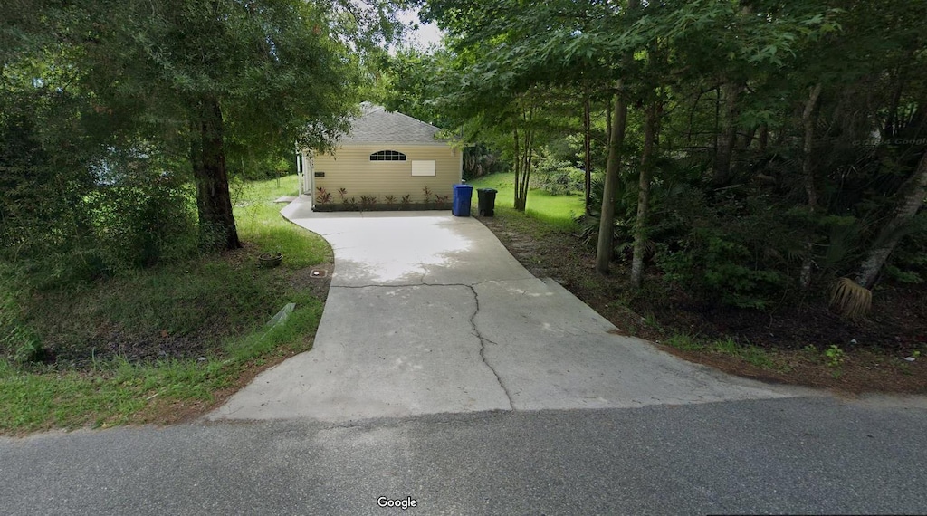 view of home's exterior with concrete driveway