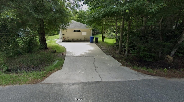 view of home's exterior with concrete driveway
