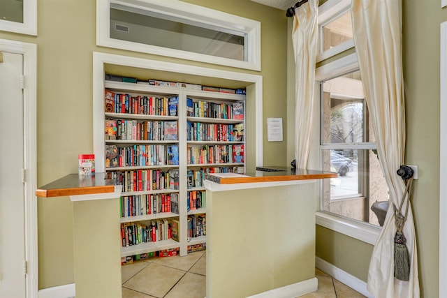 office featuring baseboards and light tile patterned flooring