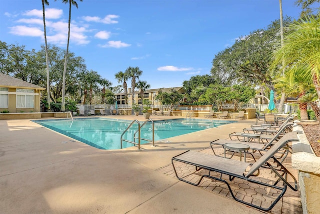 pool featuring a patio area and fence