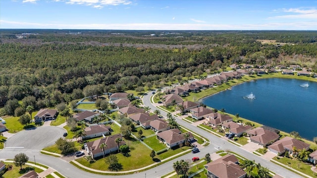 bird's eye view featuring a water view, a wooded view, and a residential view