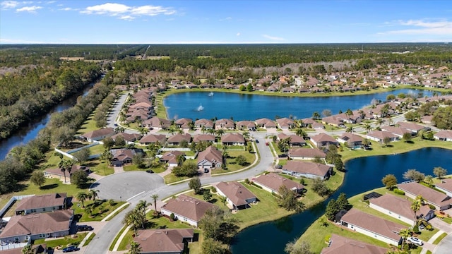 birds eye view of property featuring a water view and a residential view