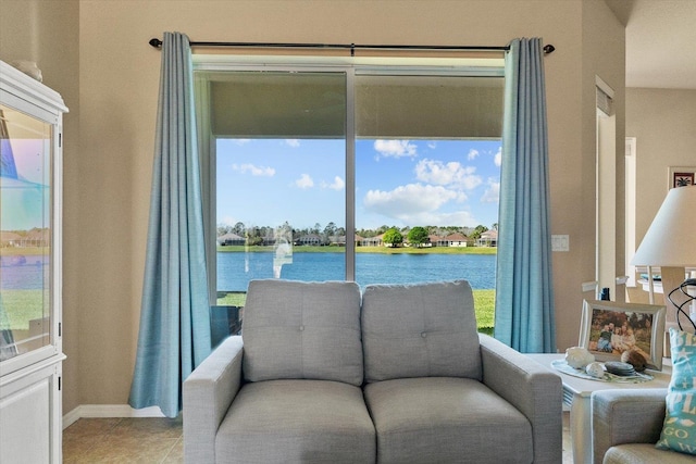 sitting room featuring a water view and light tile patterned flooring