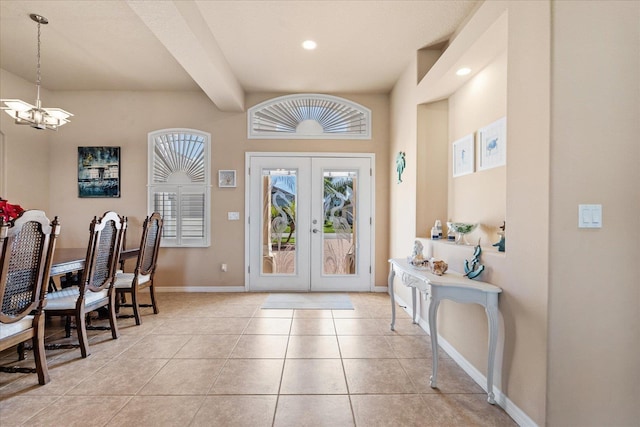 entryway featuring french doors, light tile patterned floors, an inviting chandelier, beamed ceiling, and baseboards