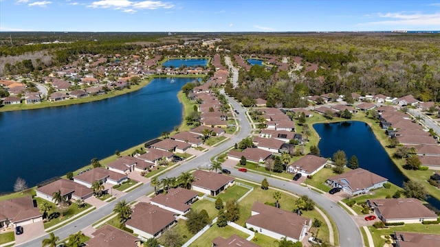 birds eye view of property with a water view and a residential view