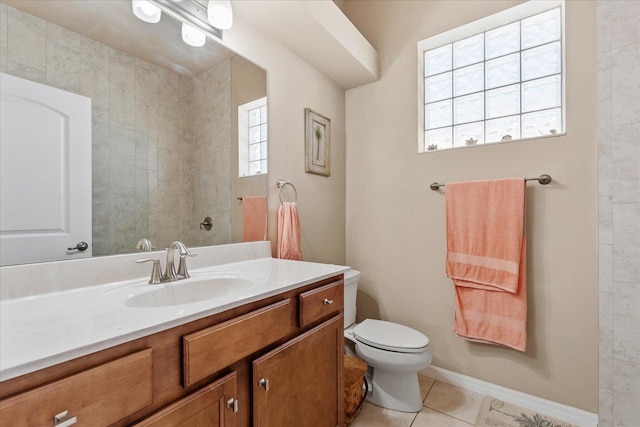 bathroom with toilet, tile patterned flooring, baseboards, and vanity