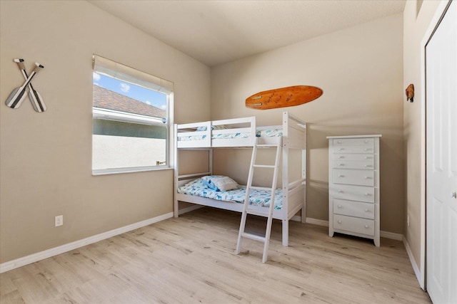 bedroom with baseboards and wood finished floors