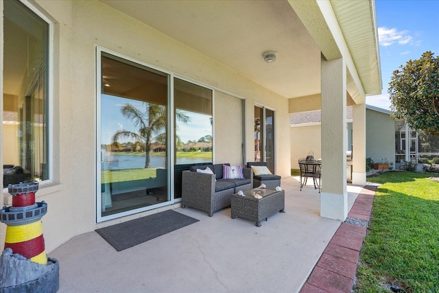 view of patio / terrace with a water view and an outdoor living space